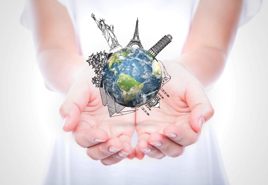 Woman's hands holding the world / Deposit Photos @ jannystockphoto