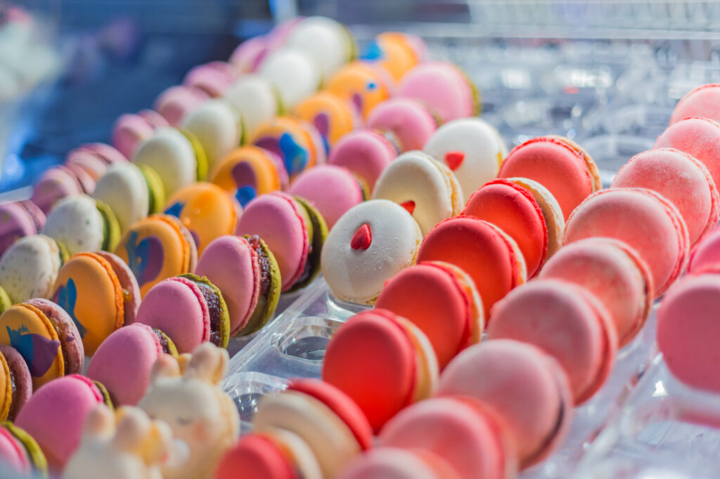 Colorful macarons for sale on counter of a bakery