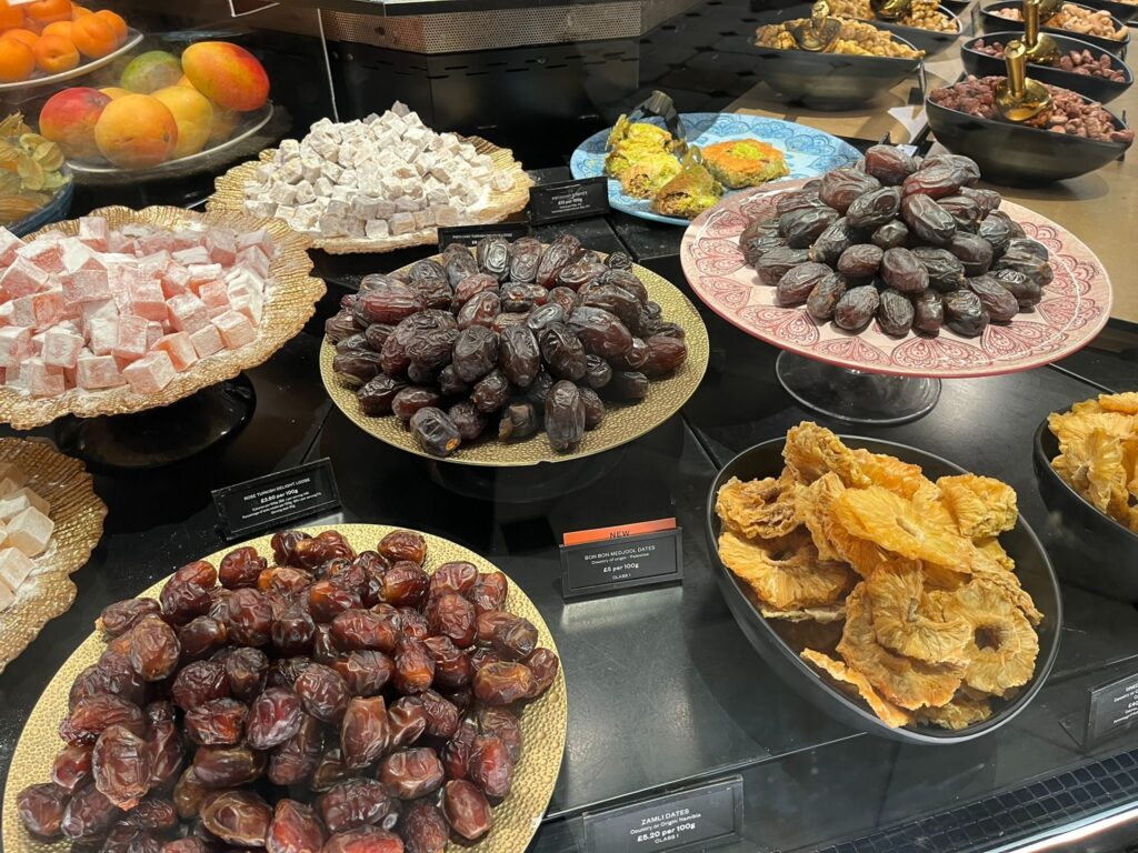 Display of dates and sweets inside Harrods Food Hall in London.