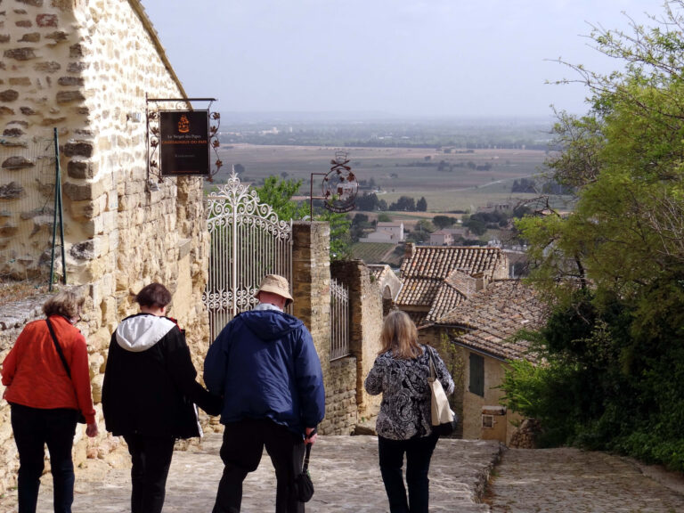 Tourists walk through the-town-Châteauneuf-du-Pape, France by Melody Moser